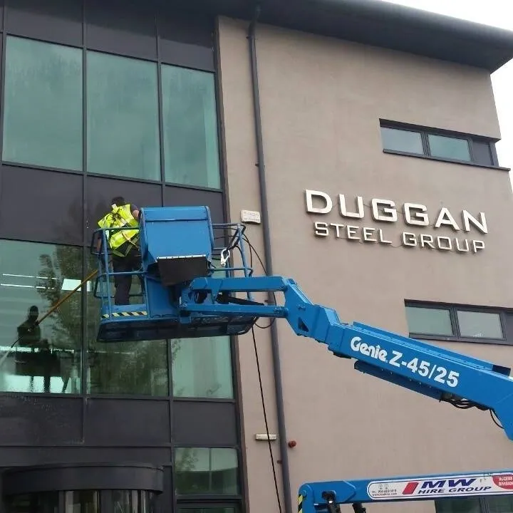Cleaning a steel-fronted office from a cherry picker